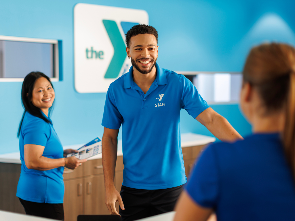Staff greet a YMCA member.