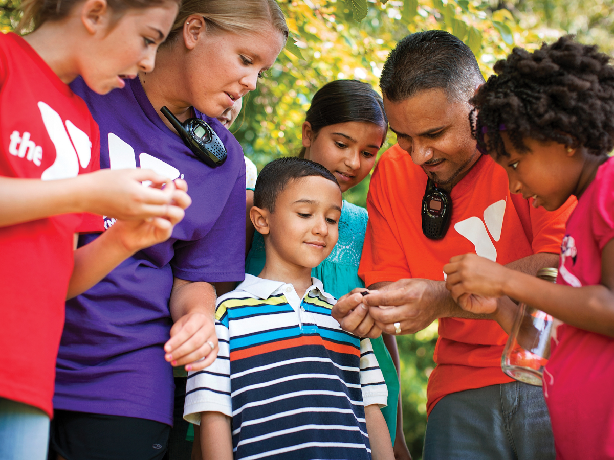 Campers and counselors explore nature outdoors.