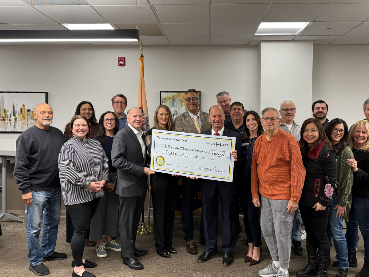 The Rotary Club of Livingston presents a check to YMCA leaders, including Cheryl Tuturice, West Essex YMCA Executive Director, and Rick Gorab, President and CEO of the Metropolitan YMCA of the Oranges, at center.