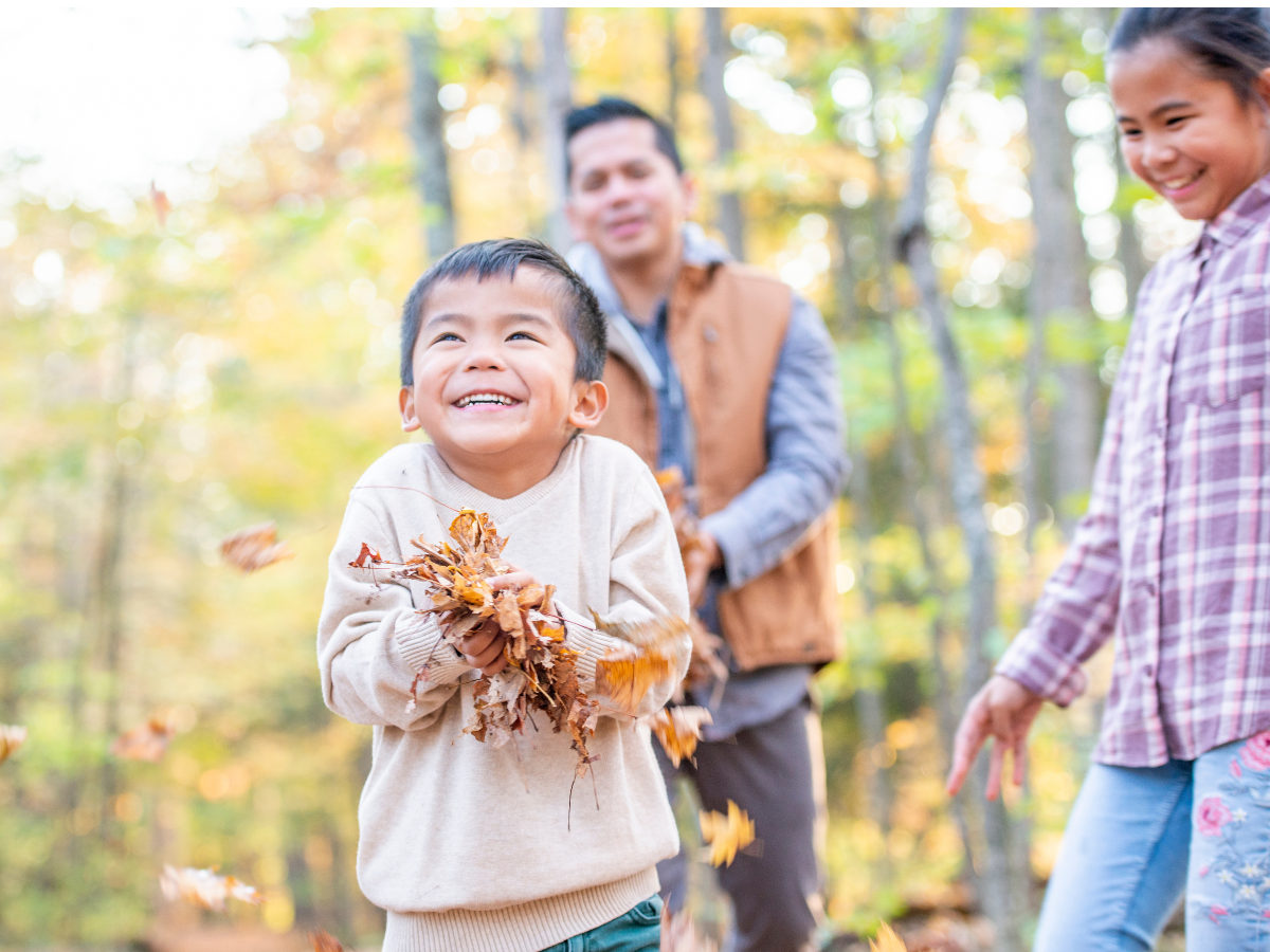 Filipino family playing outside in autumn. 