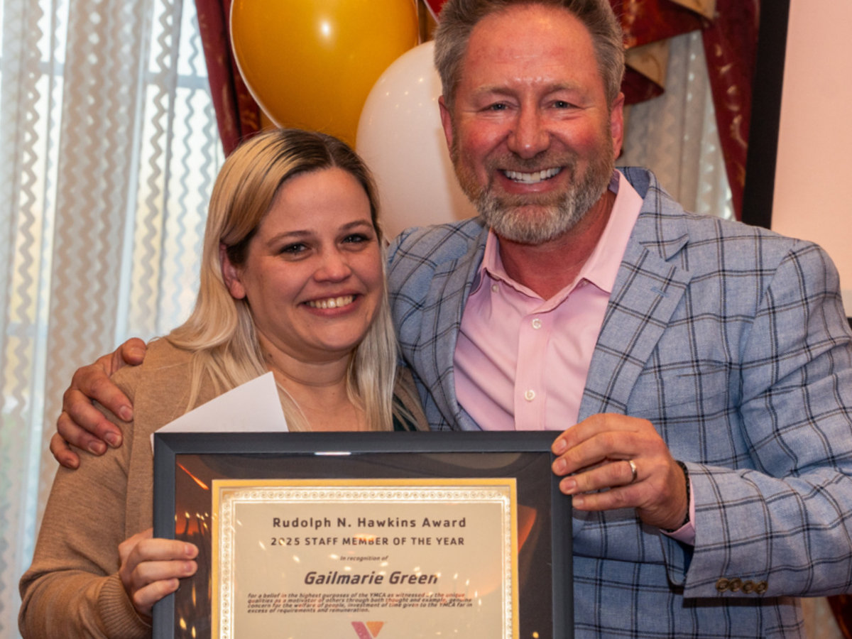 Gailmarie Green accepts the award for 2025 Staff Member of the Year from District Executive Director atSouth Mountain YMCA, James Goodger.