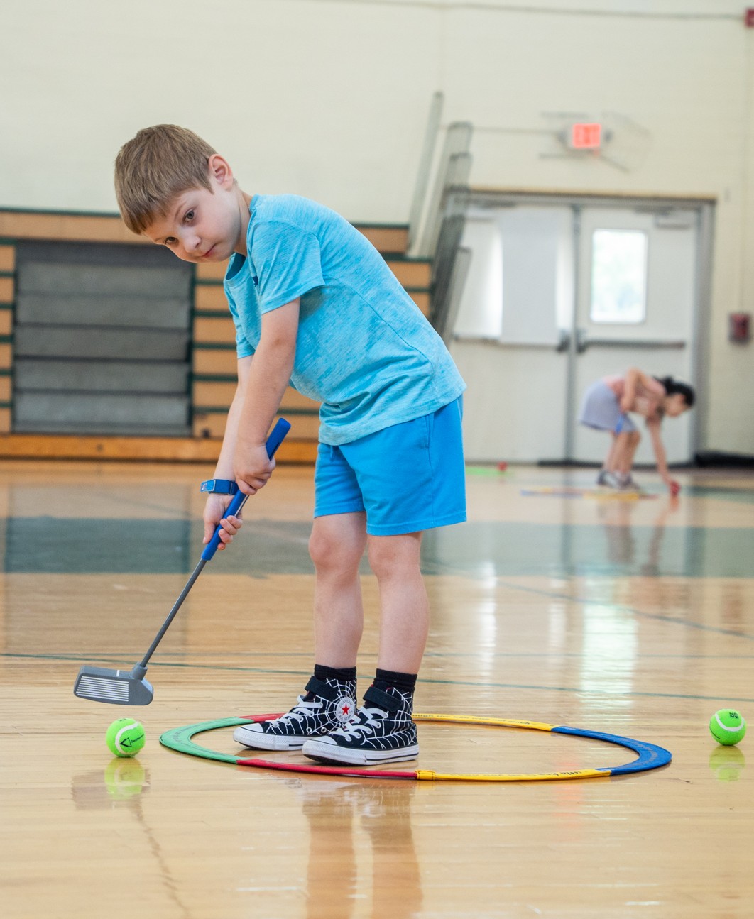 Alex Strus practices golf at West Essex YMCA's Super Summer Day Camp.