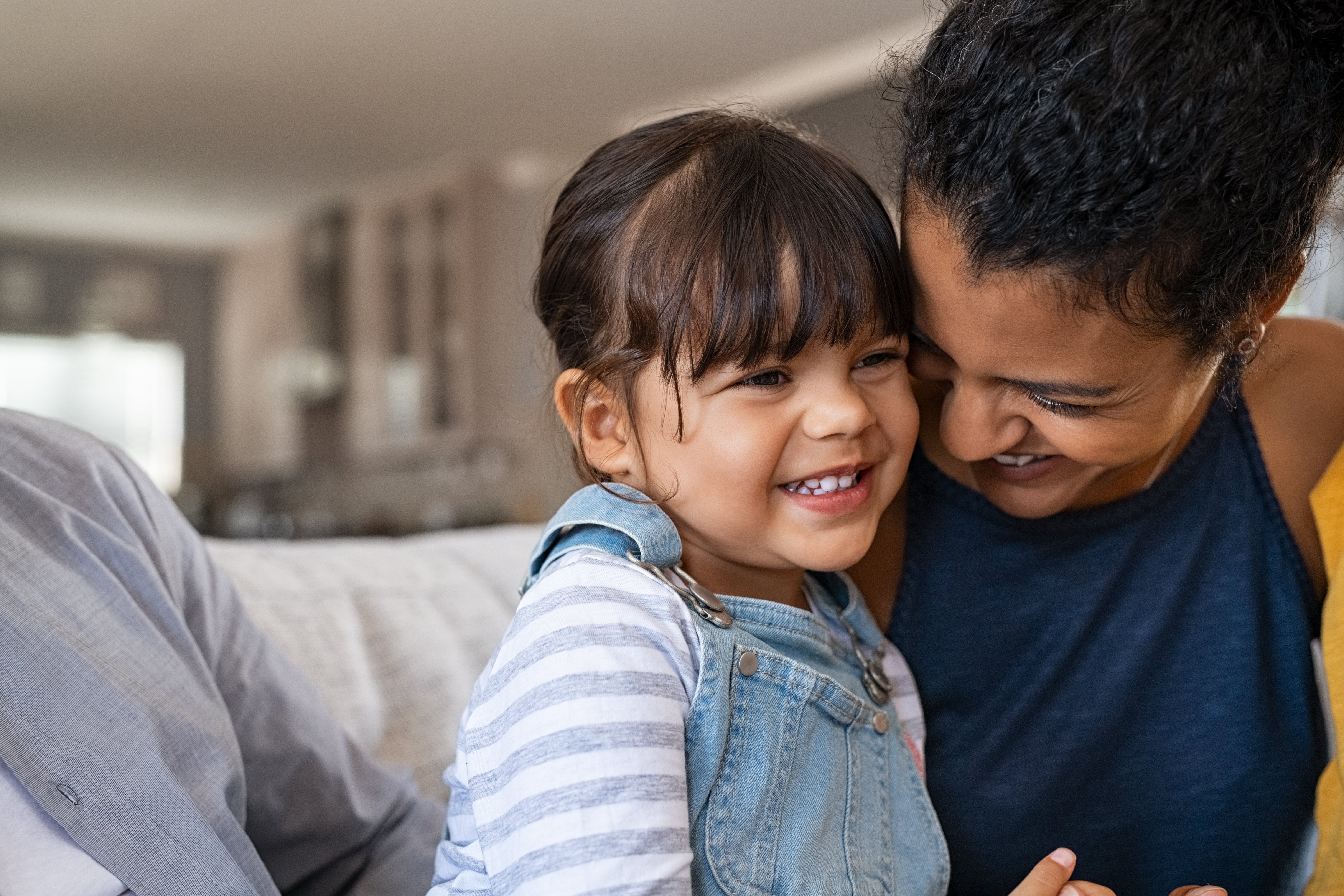 Stock image of young girl and mother having a joyful moment together.